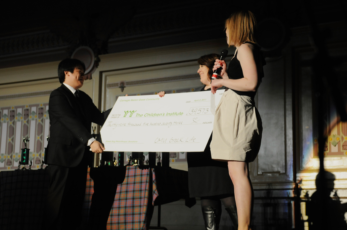 The Greek Sing chairs present a representative from the Children’s Institute with a check for a record-breaking $39,573. (credit: Courtesy of Guillermo Gomez)