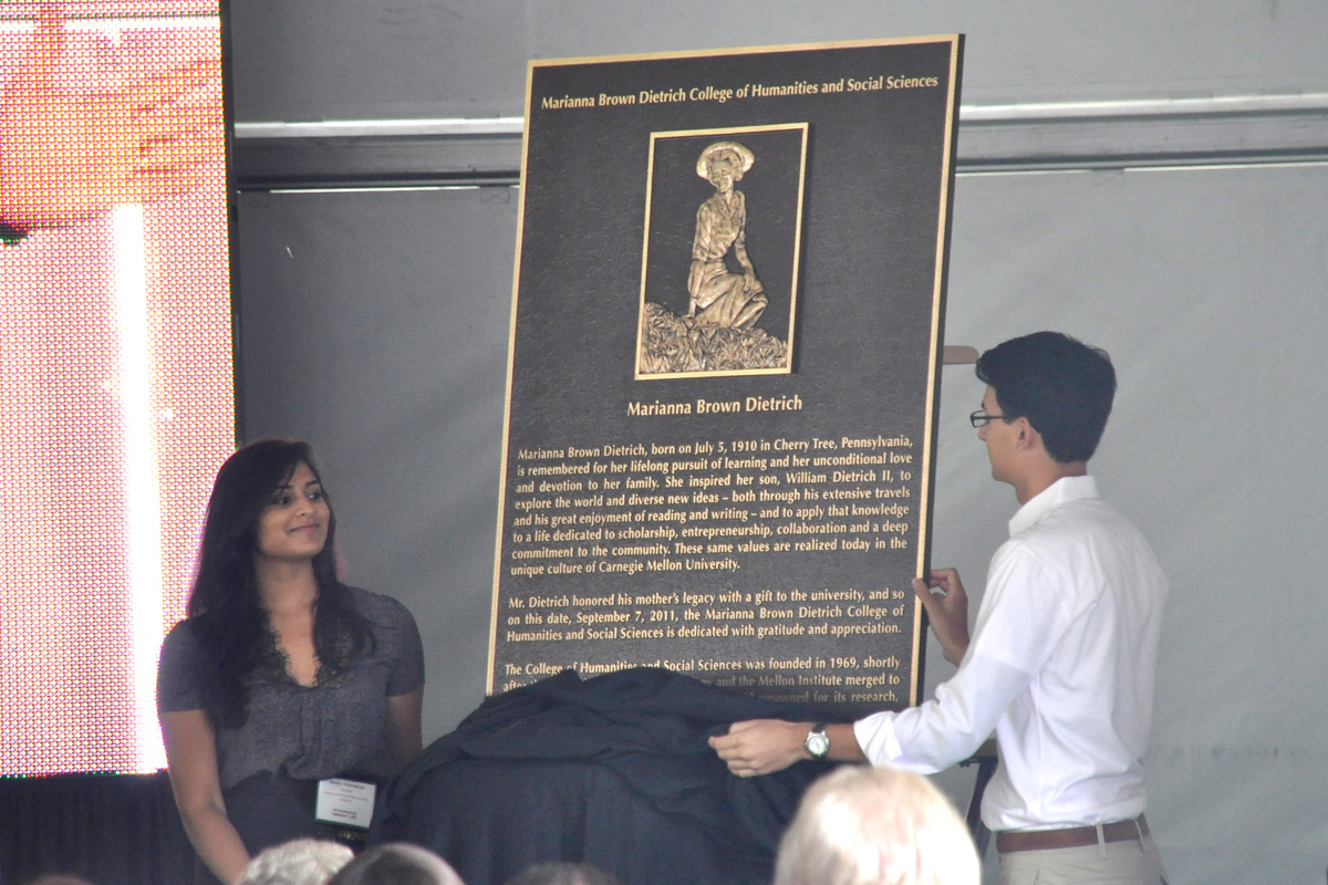 Two students unveil the plaque honoring Dietrich’s mother. H&SS was renamed in honor of Dietrich’s mother, and the plaque will be installed in Baker Hall. (credit: Alan Vangpat/Layout Staff)