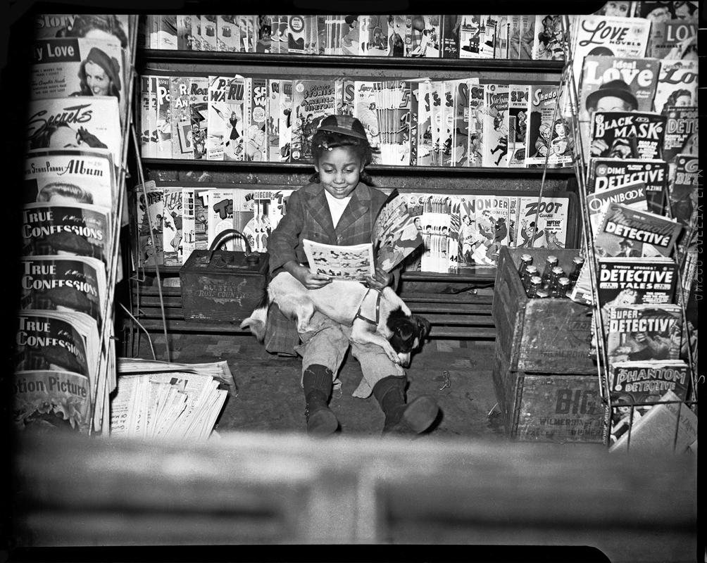 Teenie Harris photographed a wide variety of subjects, from presidents and celebrities to ordinary citizens. (credit: “Girl reading comic book in newsstand” by Charles “Teenie” Harris, courtesy of the He)