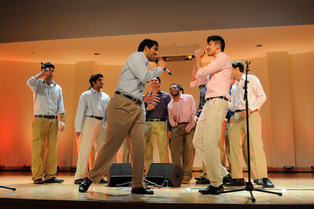 Members of the all-male, South Asian group Deewane play off each other. (credit: Courtesy of The Thistle)