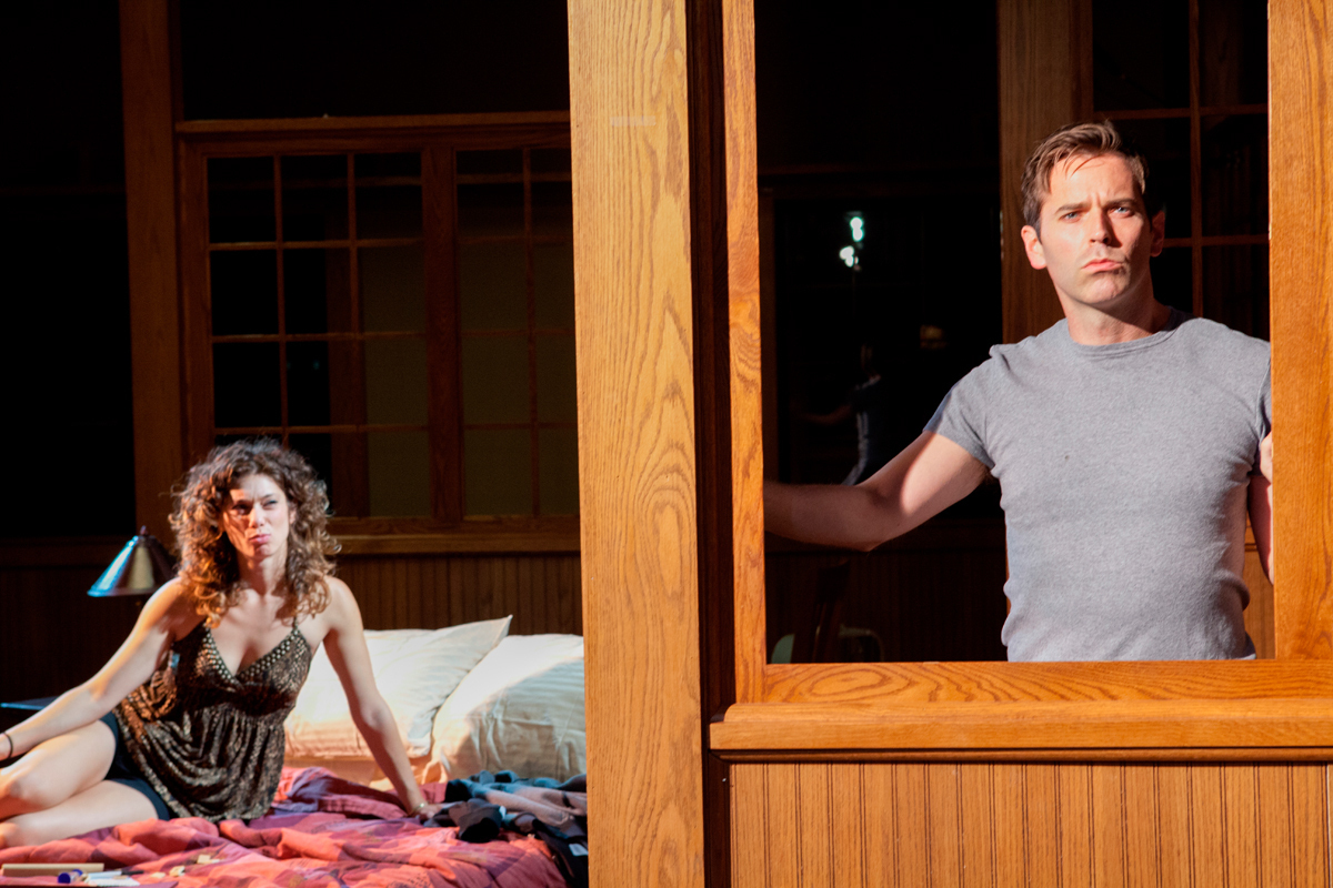 Dale (Brendan McMahon) shares a moment with his friend Ned’s wife Joy (Sarah Silk) in Quantum Theatre’s production of _Parlour Song_. (credit: Photo courtesy of Quantum Theatre)