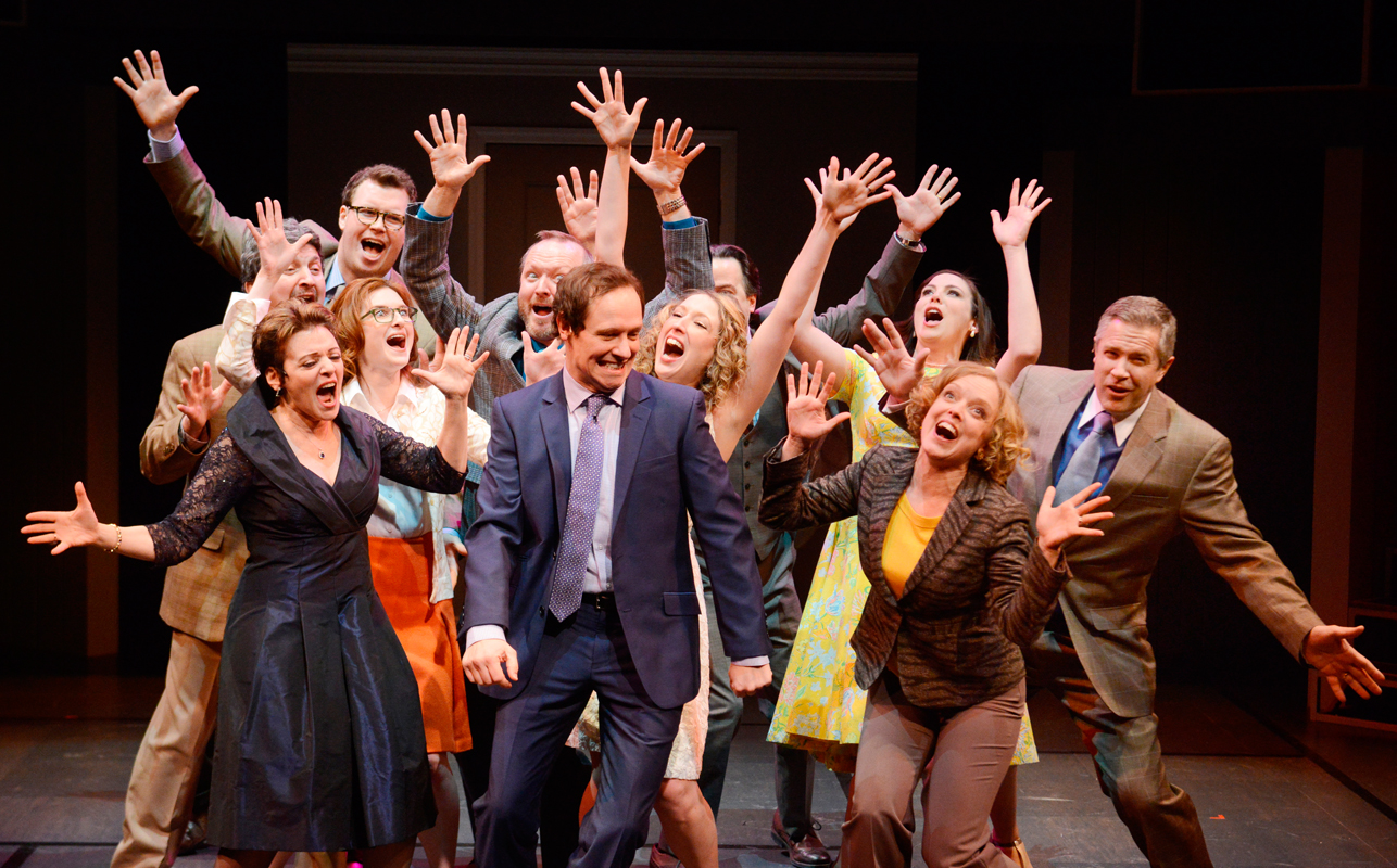 The cast of _Company_ sings around Robert, a single man who is taught by his friends to forgo his inhibitions and embrace married life. Robert is played by Carnegie Mellon alumnus Jim Stanek (CFA ‘94). (credit: Courtesy of Pittsburgh Public Theater)