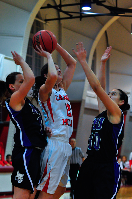 Sophomore Liza Otto shoots as the NYU Violets play defense (credit: Jason Chen/)