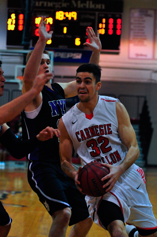 Senior Christian Manoli aggressively dribbles down the court. (credit: Jason Chen/)