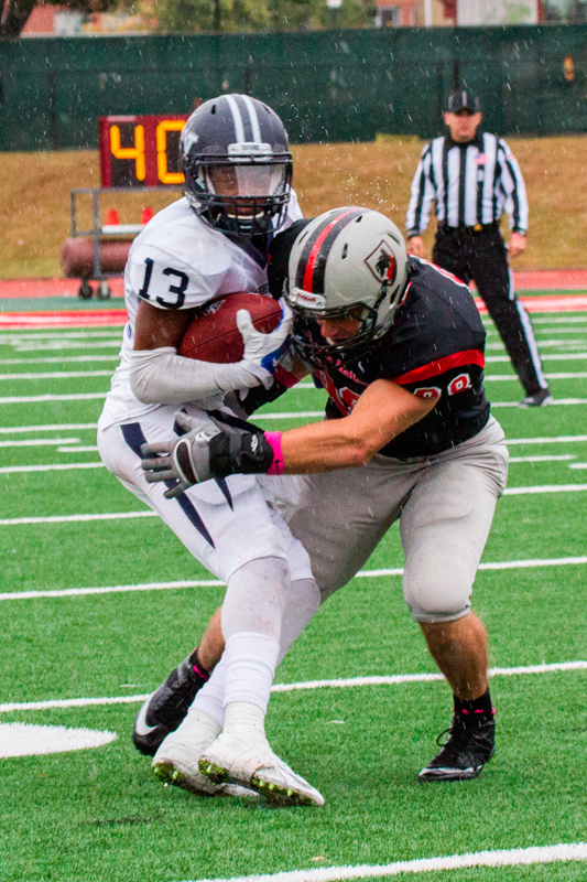 Sophomore defensive end Jack Fagan makes a tackle. (credit: Kevin Zheng/)