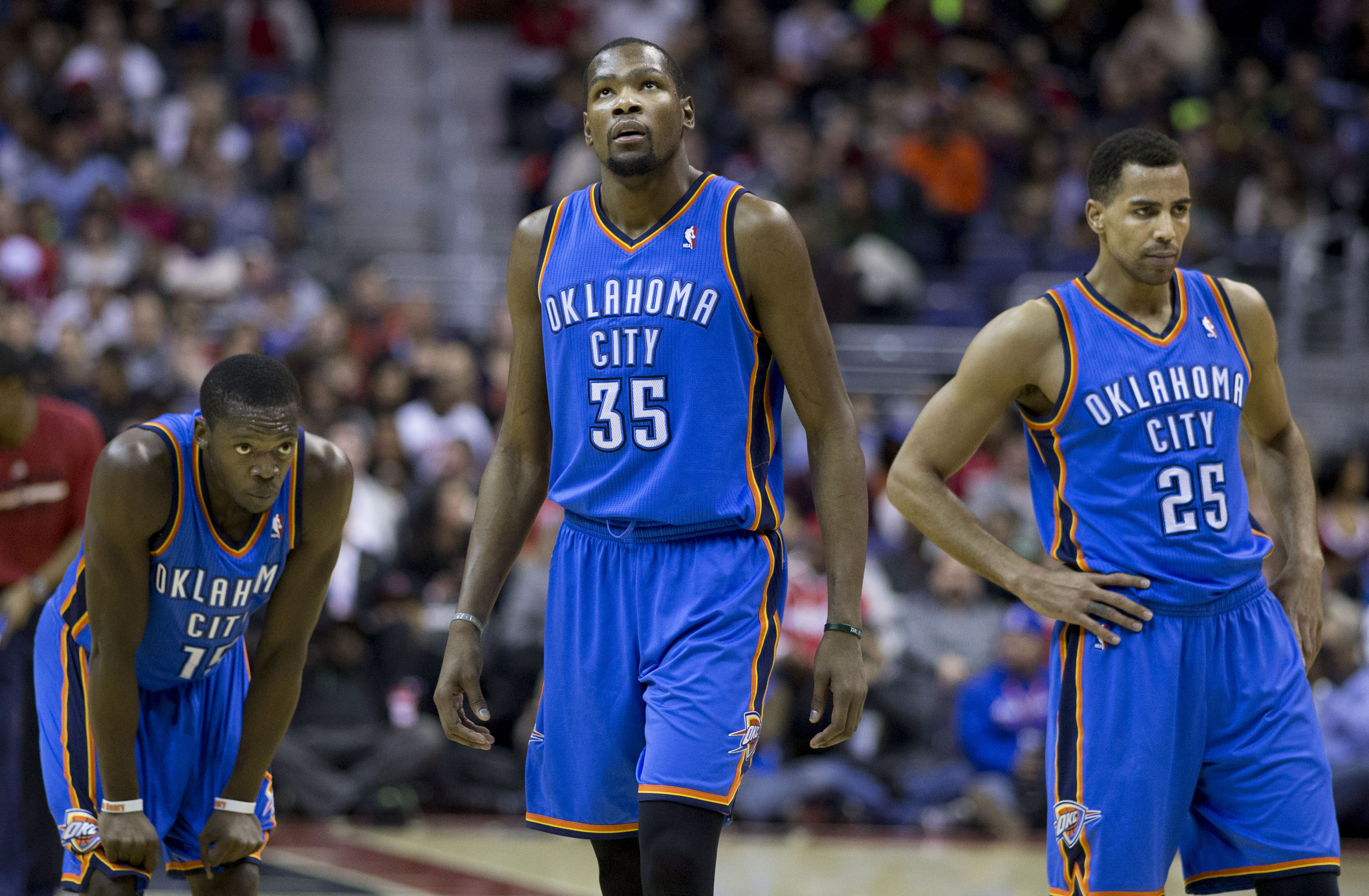 Kevin Durant and two Thunder teammates look distraught during a game, a familiar image for fans this season. (credit: Courtesy of Keith Allison via Flickr Creative Commons)