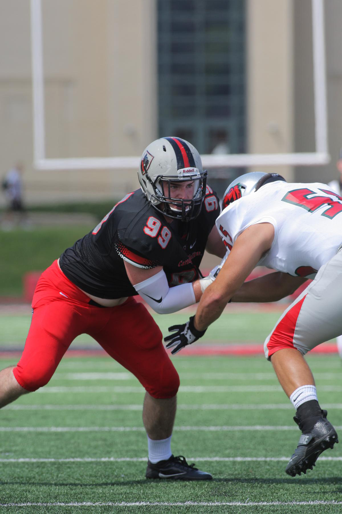 Senior defensive lineman Jack Fagan fights a defender in the loss to Washington University of St. Louis at home. (credit: Courtesy of CMU Athletics)