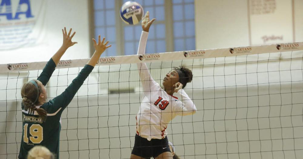First-year Sahara Aqui jumps into the air and reaches for the ball to spike it past the defender for her team. (credit: Courtesy of CMU Athletics)